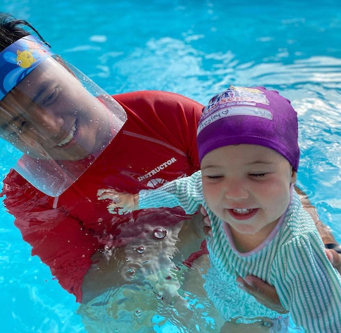Swim Instructor wearing a face shield during a swim lesson