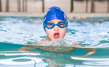 Student swimming in pool