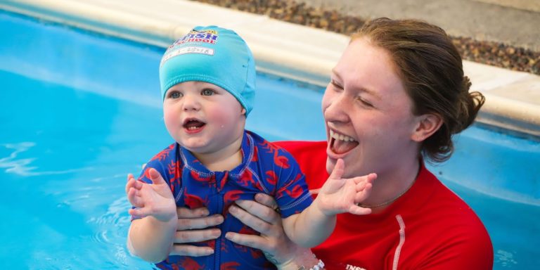 Swim Instructor teaching baby swimming lessons