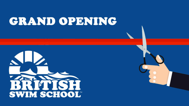 Hands with scissors cutting grand opening ribbon