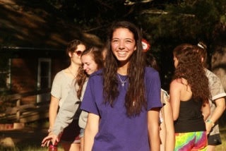 Maggie smiling with friends in the background