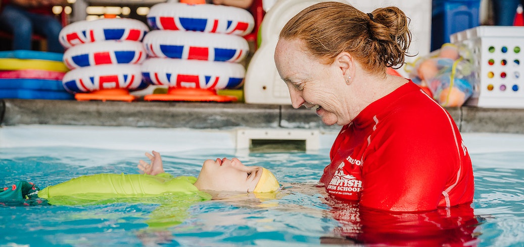 Swim instructor teaching a survival swimming lesson