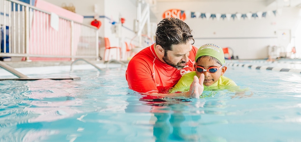 Instructor teaching a swimming lesson