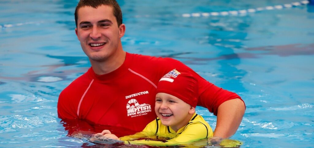 Swim instructor teaching a swimming lesson for kids