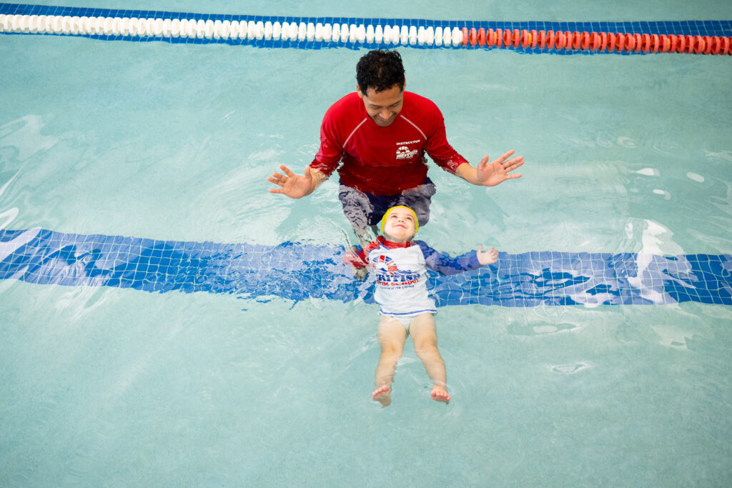 British Swim School instructors and parents teaching young swimmers during indoor swim lessons in Cypress TX