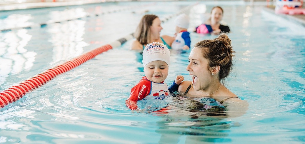 Families participating in a swimming lesson