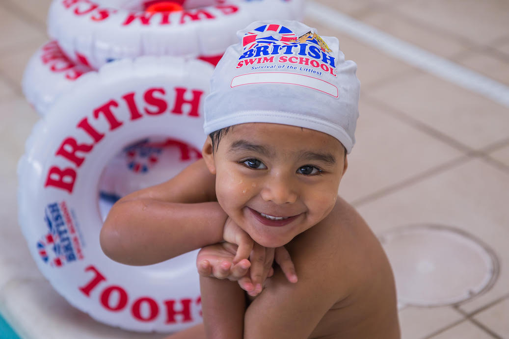 Young child taking a baby swim class