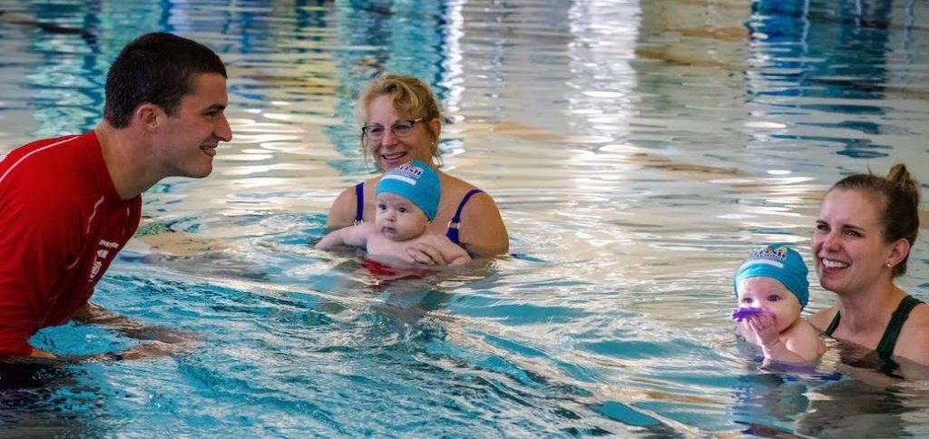 Instructor teaching a toddler swim lesson