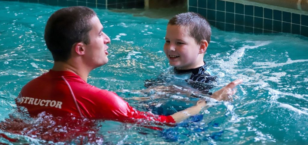 Instructor teaching a special abilities swim lessons