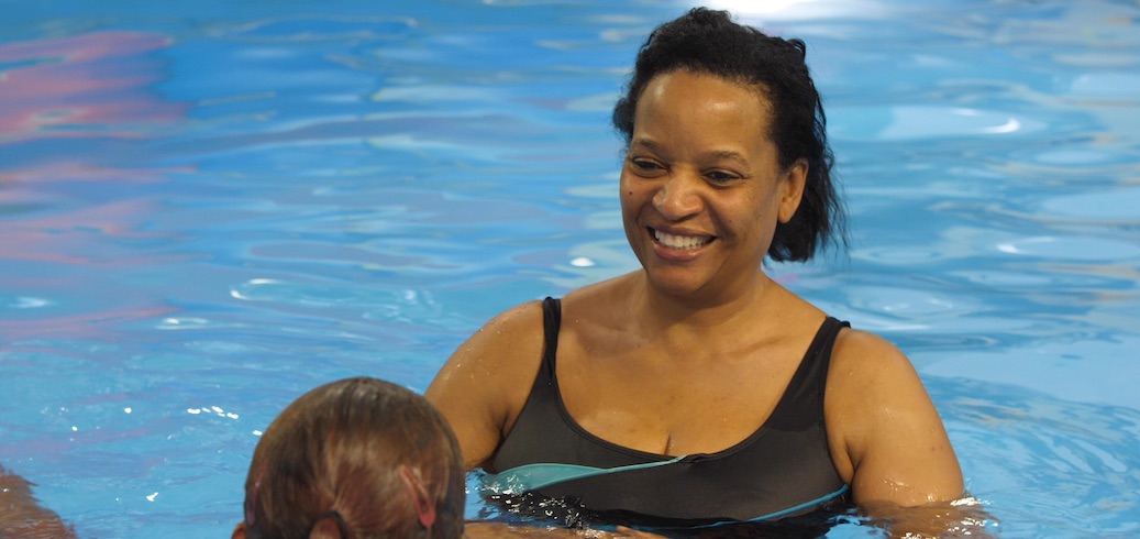 A student in a swimming class for adults