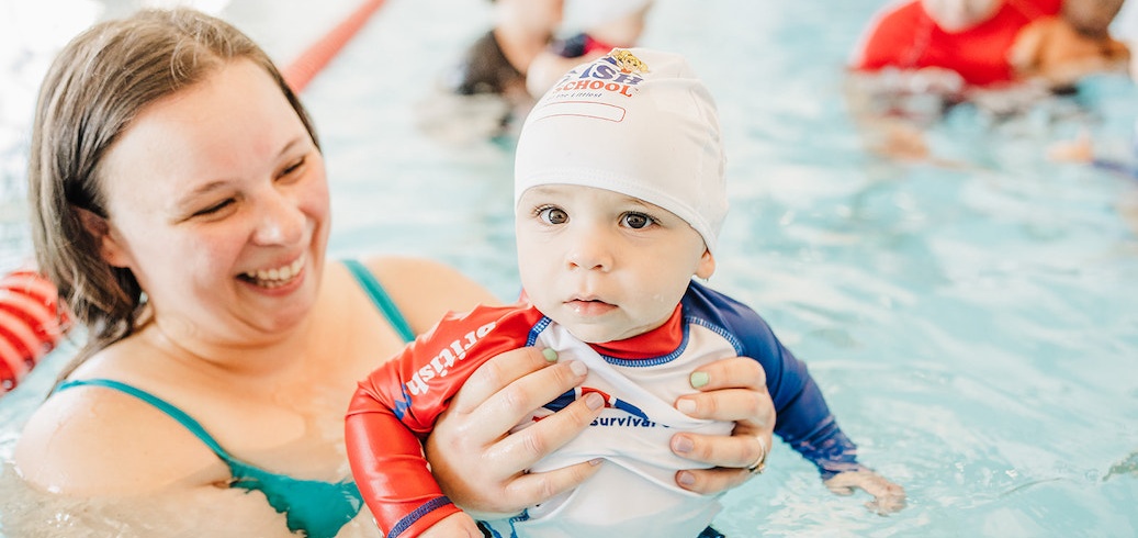 Parent and child during a mommy and me swim class