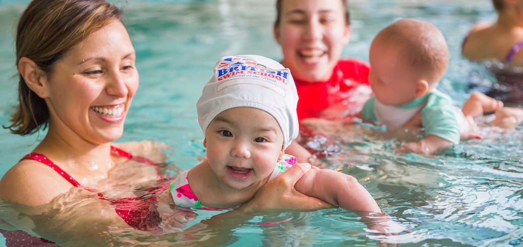 Instructor teaching a toddler swimming lesson