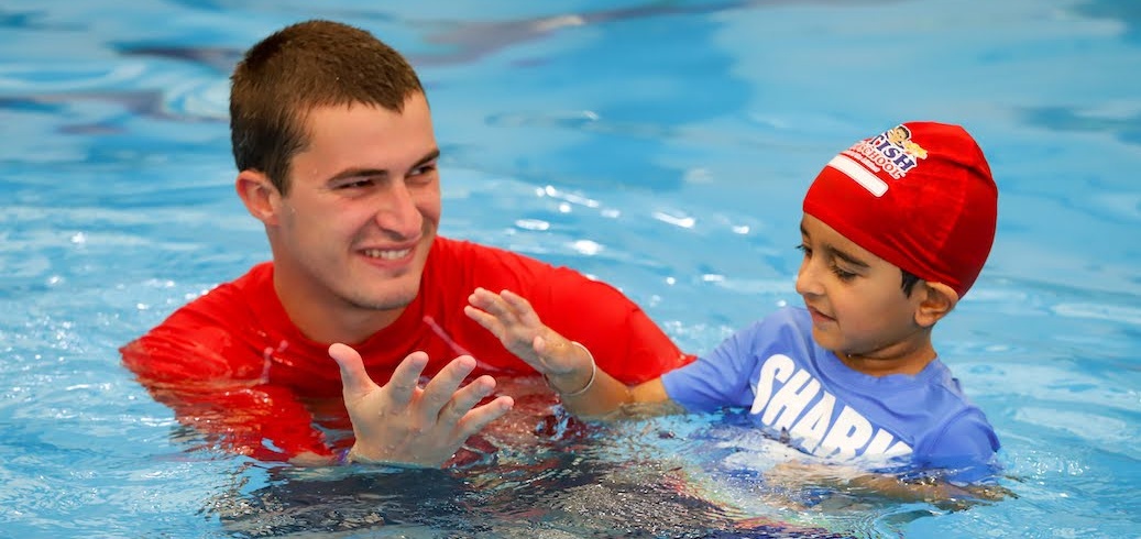 Swim instructor teaching a child swim lesson