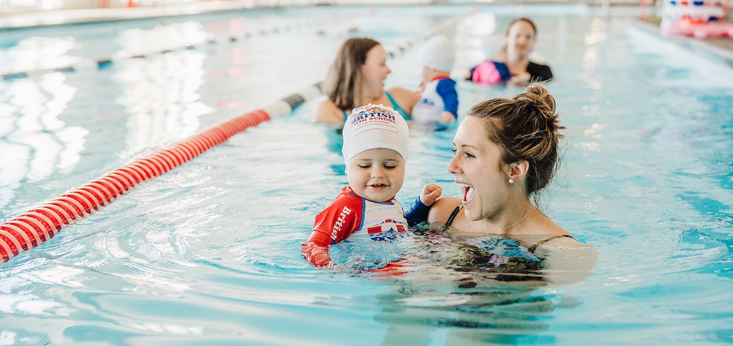 Monther and child participating in an infant swim class