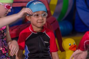 Swim student in a swim cap and goggles