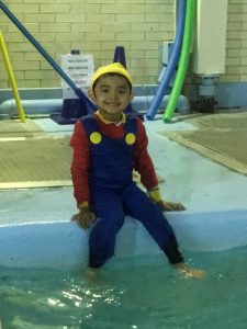 Child in halloween costume at the pool