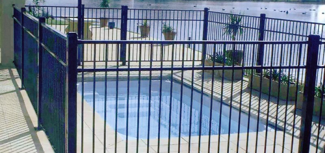 Four-sided isolation fence around a backyard pool
