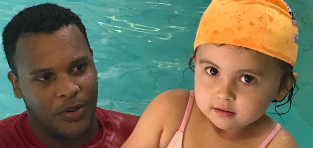 Swim instructor in the pool with a child