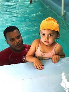 Child and swim instructor in the pool