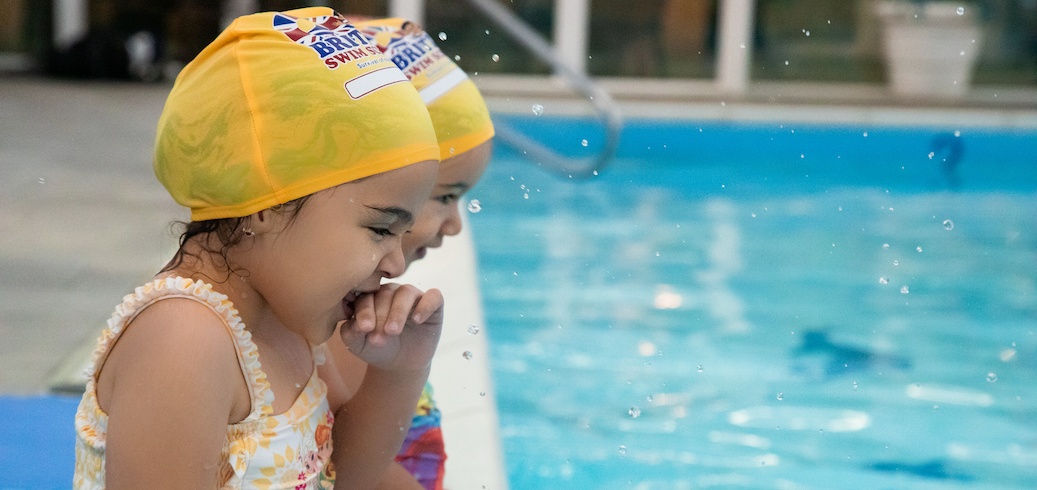Two children enrolled in a swimming class