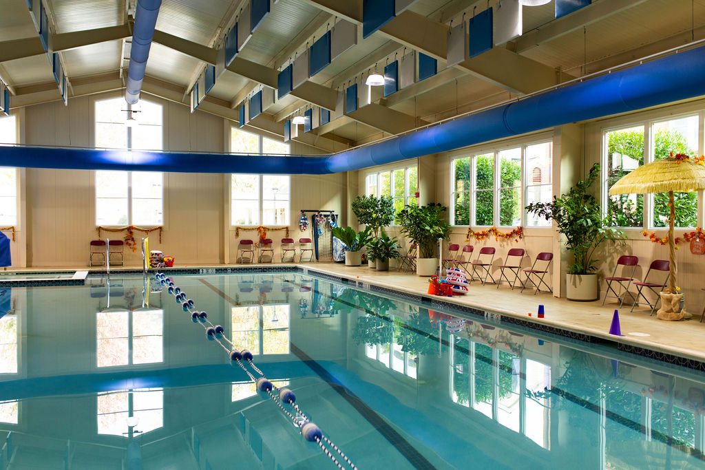 Indoor swimming pool at British Swim School in Lititz PA with lane dividers and seating for swim lessons
