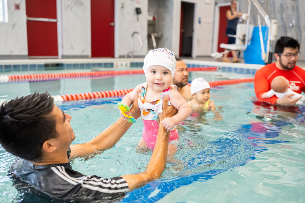 3 month old child enjoying swim lessons with British Swim School