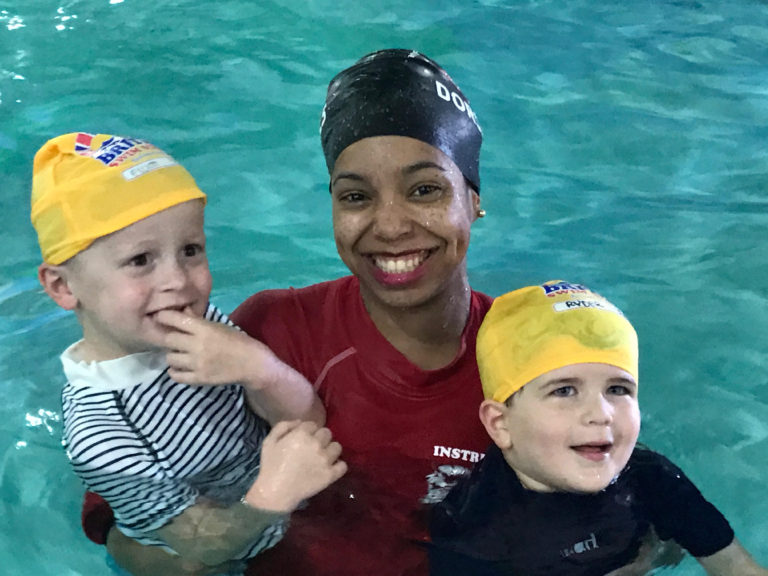 Christina Spann, Aquatics Director, in the pool with two children