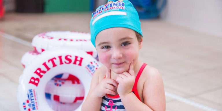 Little girl in a British Swim School swim cap