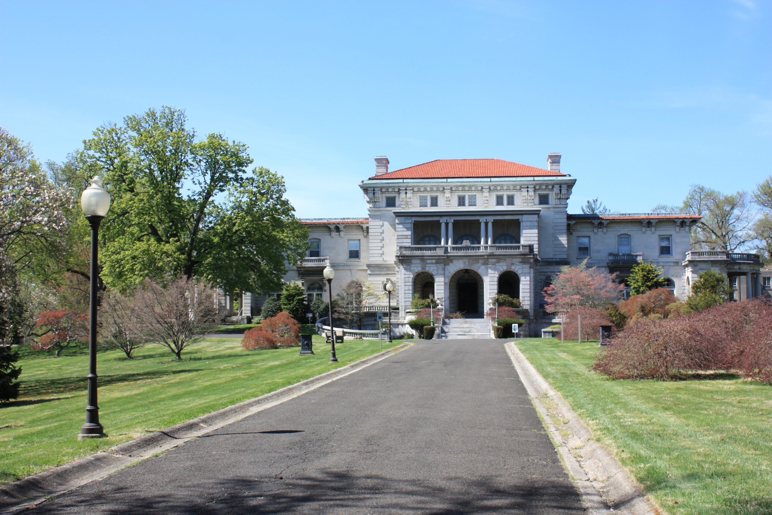 The magnificent Elkins Estate in Elkins Park, Pennsylvania, featuring its grand Italian Renaissance mansion with a terracotta tile roof, detailed stone facade, and elegant arched loggias overlooking expansive manicured lawns. British Swim School offers year-round, indoor swim lessons for the Montgomery County community and surrounding Elkins Park, Jenkintown, Glenside, and Abington neighborhoods.