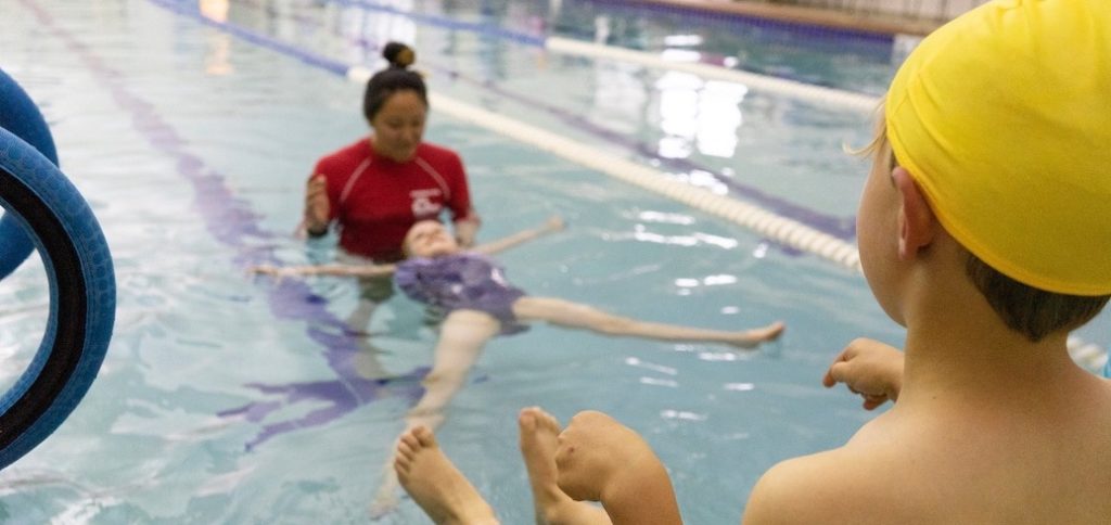 Student participating in a survival swim lesson