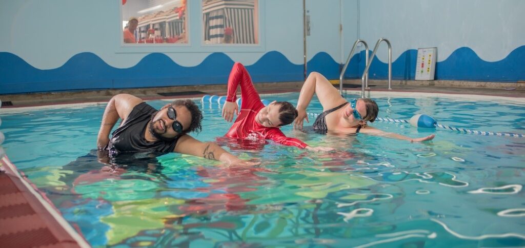 Swim instructor teaching an adult swimming lesson
