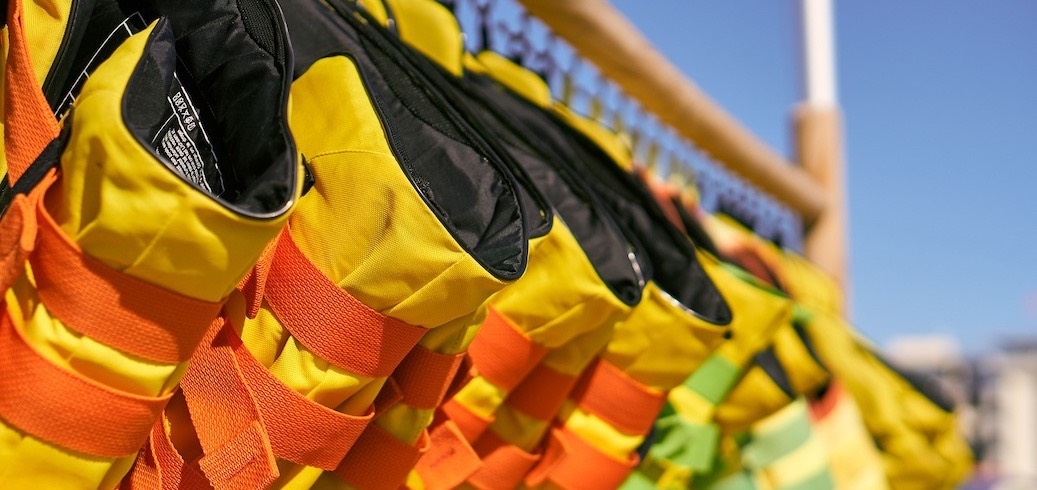 Life jackets hanging on a rack