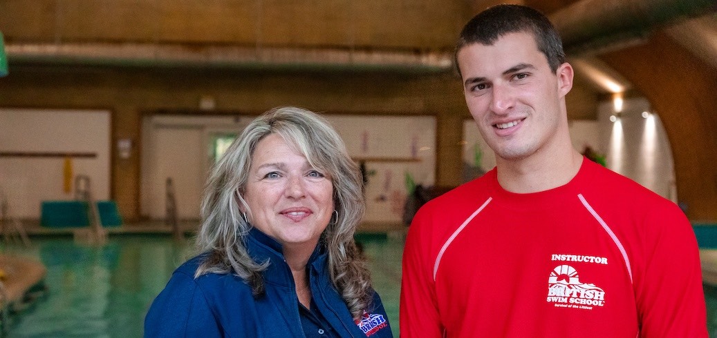 A British Swim School franchise owner standing with a swim instructor