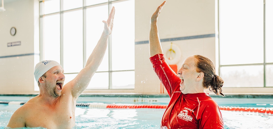 Swim instructor teaching an adult swimming lesson