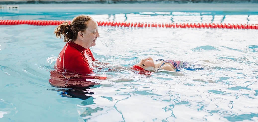 Swim instructor teaching a survival swimming lesson