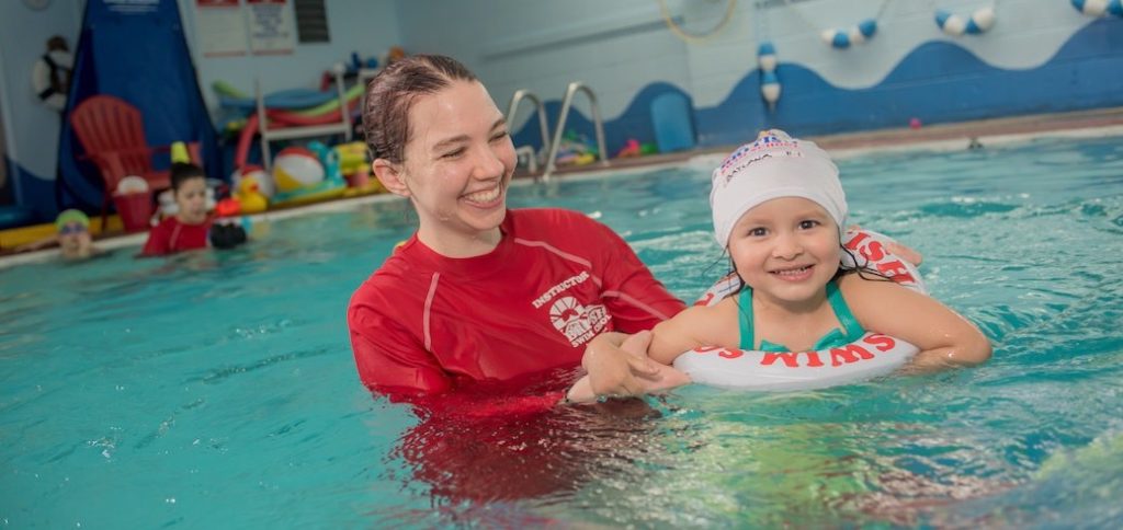 Young child participating in a toddler swimming lesson