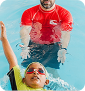 A young swimmer practising with an instructor