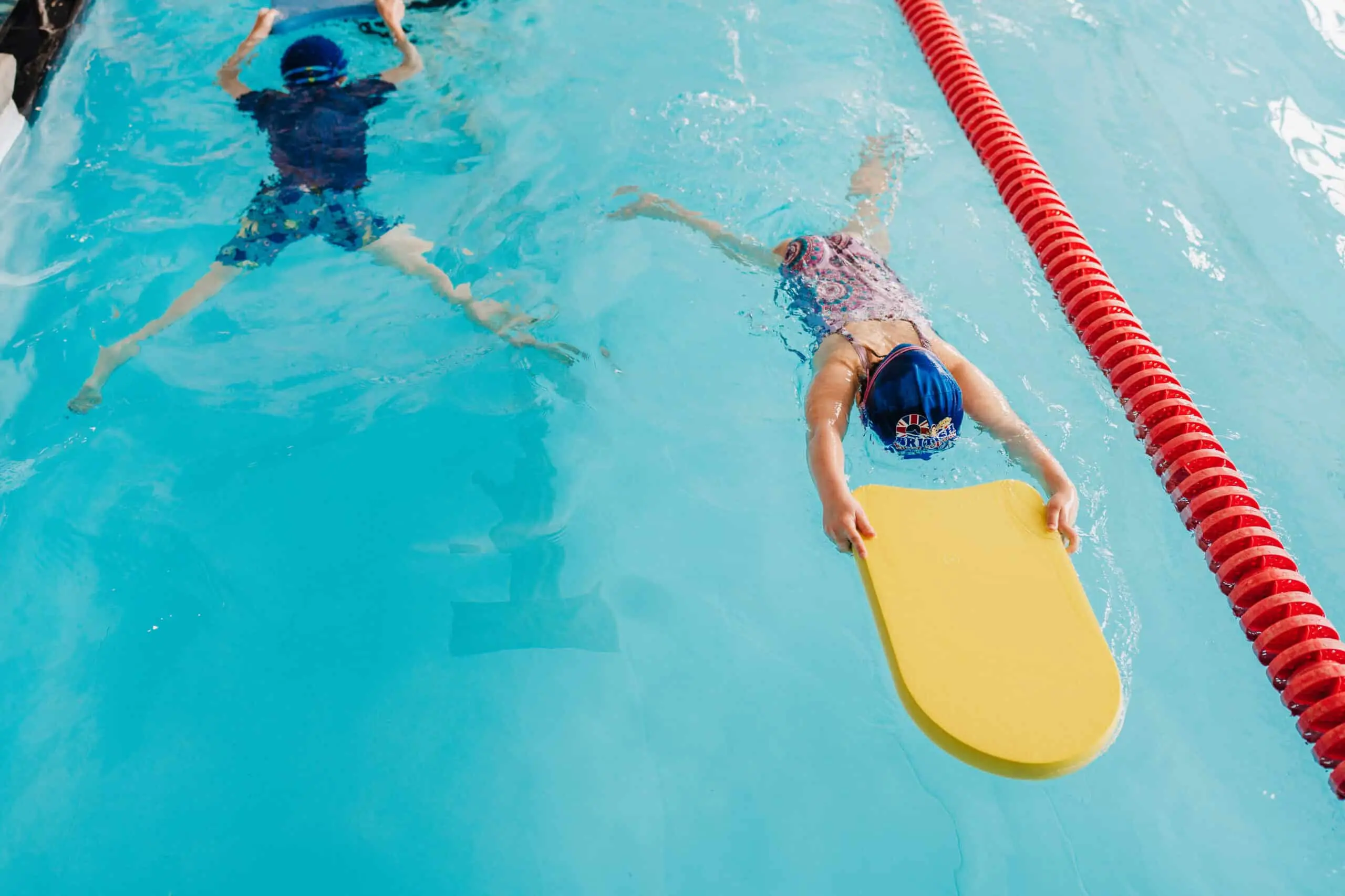 Child practising water survival skills with an instructor