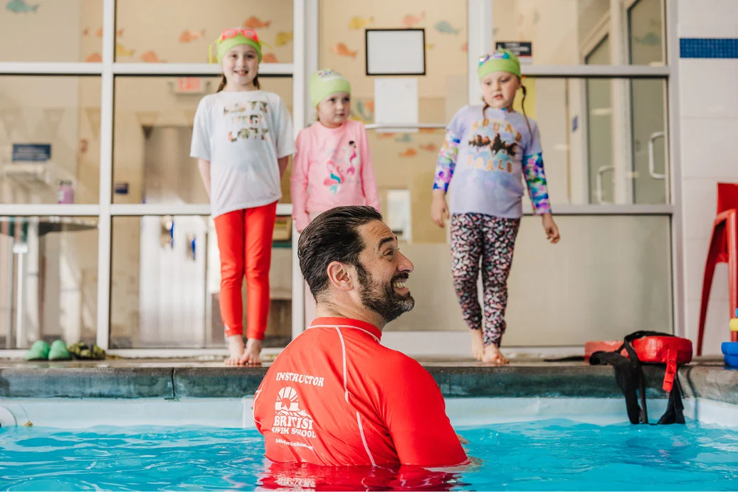 Students participating in Survival Week wearing clothes over swimsuits