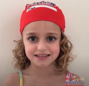 Young girl wearing a British Swim School swim cap