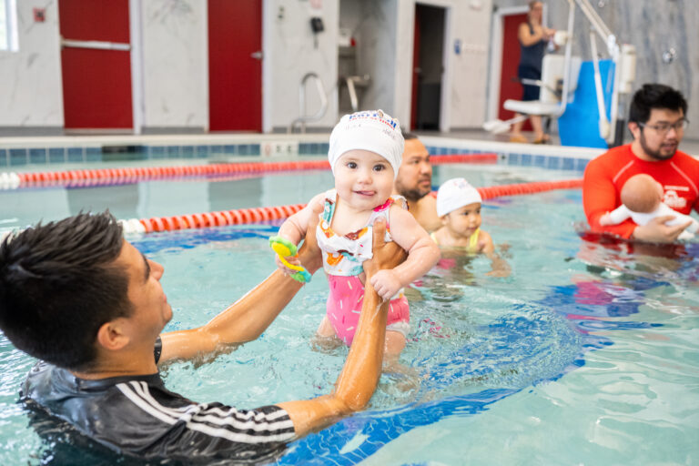 3 month old child enjoying swim lessons with British Swim School